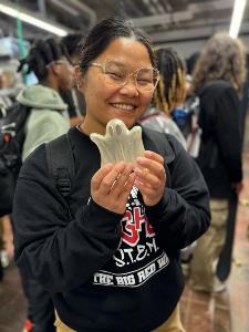 student2 holding up a ghost 3D printed artifact